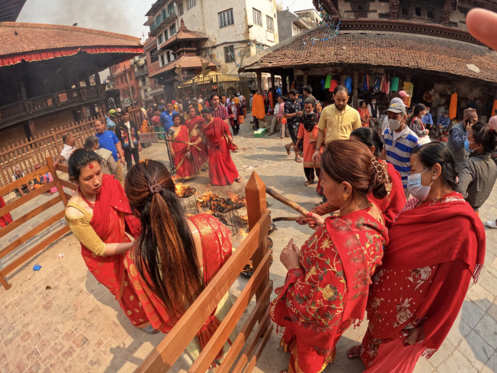 Nepálske ženy v tradičnom oblečení vykonávajúce rituál v uliciach Káthmandu 